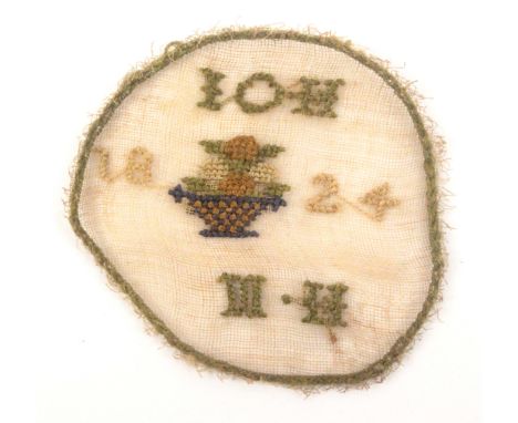 A miniature watch sampler, circular initialled and dated ‘IOH / MH / 1824’, around a basket of fruit within a stitched border