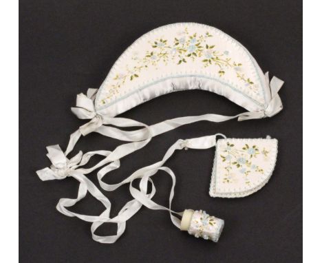 An unusual ribbon form chatelaine, early 20th Century, comprising a large crescent form pin cushion, one side in neatly stitc