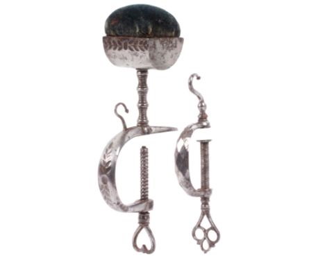 Two steel sewing clamps, comprising an example with ‘C’ frame and pierced heart shaped screw terminal, the frame with leaf de