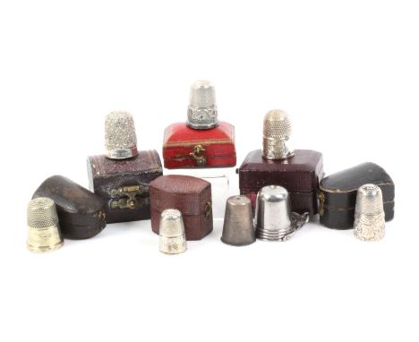 Six cased thimbles and a steel chatelaine bucket with thimble, comprising a hallmarked silver thimble in rectangular box, a s