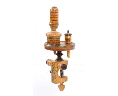 An elaborate whitewood paint decorated Tunbridge ware sewing clamp, the rectangular frame mounted with a pair of thread barre