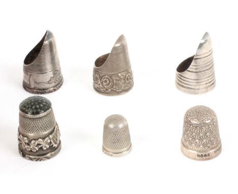 Six English silver thimbles, comprising three thimble guards, two with decorative friezes, two children’s thimbles, and a sil