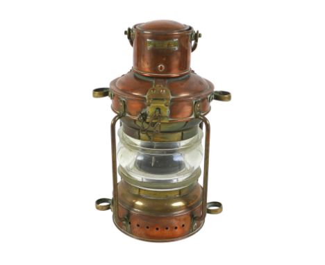 A copper buoy lantern, Pascall, Atkey &amp; Sons, Cowes, with dioptric glass lens, paraffin burner, and brass handle, 30cm hi