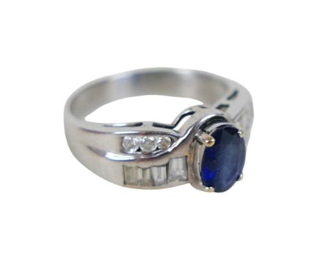 A diamond and sapphire ring on 18ct gold band, band marked 18k, oval sapphire and baguette and brilliant cut diamonds to the 