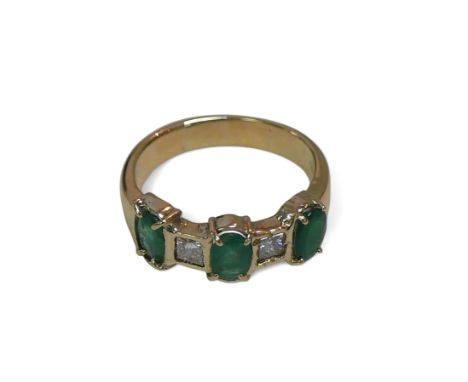 An 18ct gold, emerald and diamond ring, the three oval emeralds and two princess cut diamonds, band marked 750, size N, 4.7g
