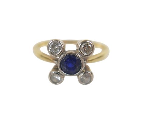 An 18ct yellow gold and platinum ring, set with a sapphire surrounded by four diamonds, size N, 3.4g.
