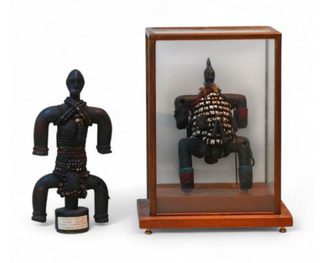 Two West Cameroon, Namji tribal fetish figures, one with a glass case, figure, 27cm high, cased, 31 by 22 by 40cm high overal
