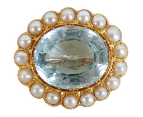 An Edwardian 18ct yellow gold brooch / pendant, set with a blue topaz, 17 by 19 by 10mm, surrounded by 4mm pearls, 11.5g, 31m