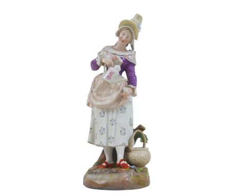 A 19th century Meissen porcelain figure of a lady pouring from a coffee pot wearing a bonnet, 28cm high.
