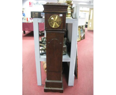 An Oak Grandmother Clock, with a caddy top, brass dial, shaped door, on a plinth base.