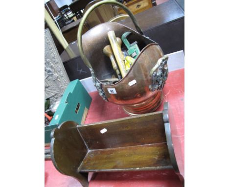 A Victorian Copper Coal Helmet, with brass swing handle containing DIY tools and a mahogany book rest. (2)