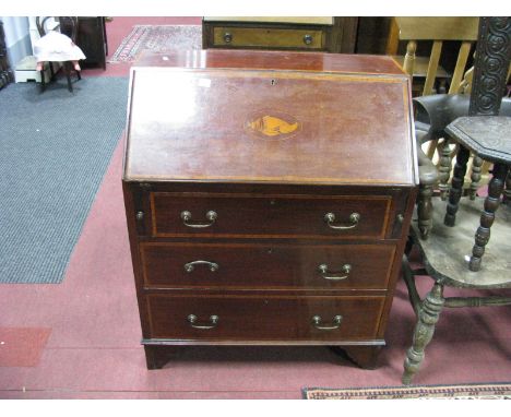 An Edwardian Mahogany Bureau, with a crossband top, fall front with shell inlay, fitted interior, three graduated drawers on 