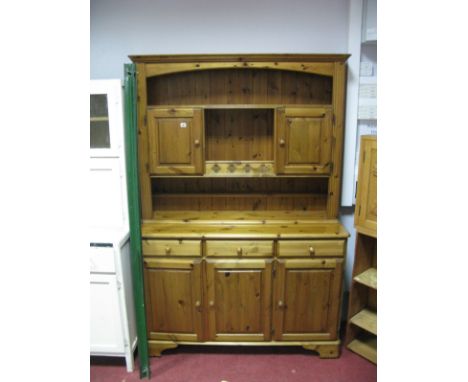 A Modern Pine Dresser, the top with open shelves and cupboard doors over a frieze of three small drawers and cupboard doors b