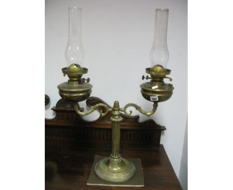 A Brass Twin Oil Lamp, having scroll arms and reeded support on circular base.