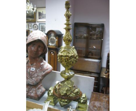 XVII Century Style Brass table lamp, in the form of a candlestick, with scroll and decorated heads.