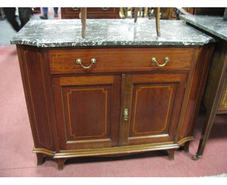 An Edwardian Mahogany Inlaid Washstand, with a marble top, long drawer over two panelled cupboard doors, on swept bracket fee