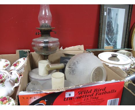 An Early XX Century Oil Lamp, pierced cast iron base, clear reservoir, later shade. A reproduction coaching lamp, 1960's shad