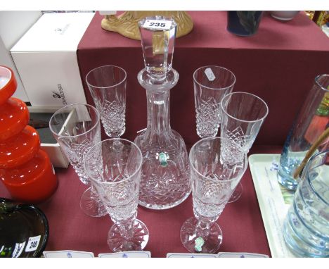 A Waterford Glass Bell Shaped Decanter, having octagonal stopper; together with six tall champagne flutes on baluster stems.