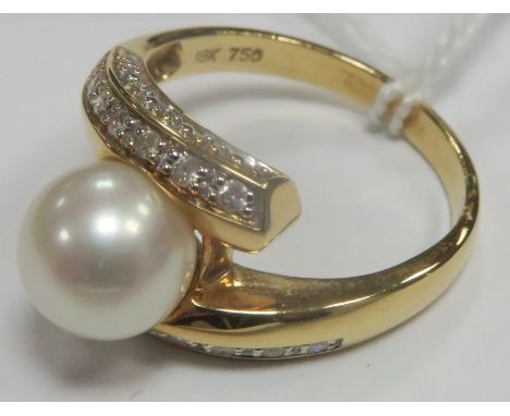 A Pearl Set Ring, set to the centre within crossover setting with inset highlights, stamped "750" "18K".