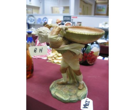 A Royal Worcester "Hadley" Sweetmeat Dish, modelled in the form of a boy carrying a large basket upon a rocky green, the base