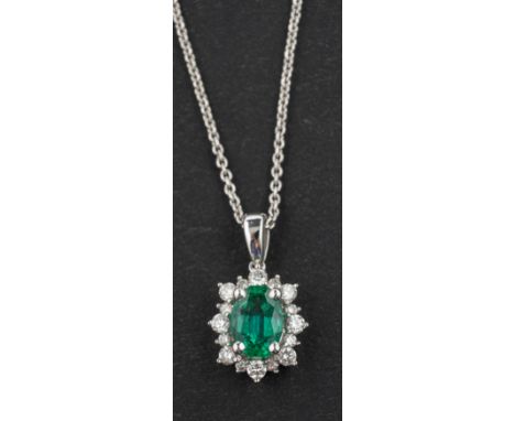 An 18ct gold, cushion-shaped, mixed-cut emerald and diamond cluster pendant, emerald weight 0.67ct and diamond weight 0.24cts