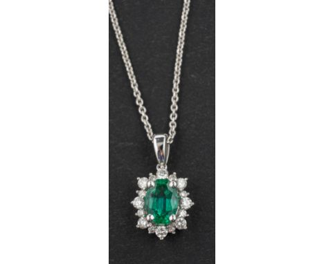 An 18ct gold, cushion-shaped, mixed-cut emerald and diamond cluster pendant, emerald weight 0.67ct and diamond weight 0.24cts