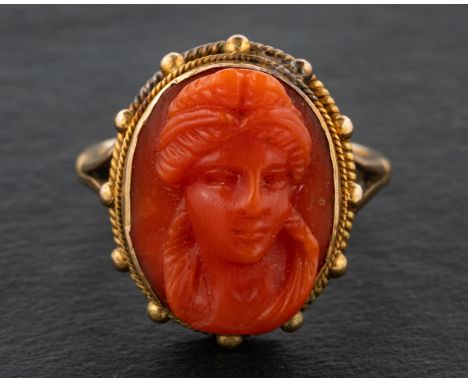 A 19th century, coral cameo ring, depicting the head of a lady, with ropework surround, length of ring head ca. 1.8cm, ring s