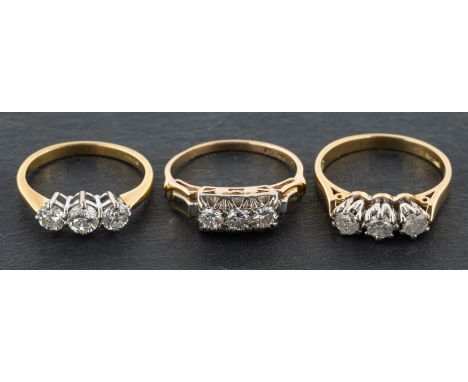 Three, round brilliant-cut diamond, three-stone rings, including an 18ct gold ring, total estimated diamond weight ca. 0.45ct