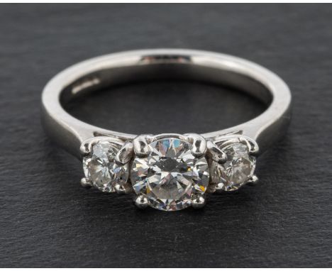 A platinum, round, brilliant-cut diamond three-stone ring, total estimated diamond weight ca. 1.10cts, H-I colour, SI1-2 clar
