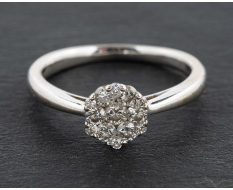 An 18ct gold, round, brilliant-cut diamond cluster ring, total estimated diamond weight ca. 0.25ct, with partial hallmarks fo
