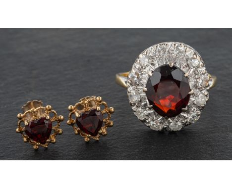 A garnet, single and round, brilliant-cut diamond cluster ring, total estimated diamond weight ca. 0.60ct, H-I colour, P1-2 c