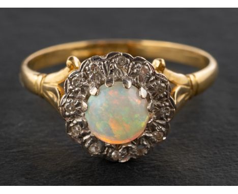 An 18ct gold, round, cabochon-cut opal and single-cut diamond cluster ring, estimated opal weight ca. 0.80ct, total estimated