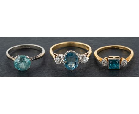 Three gemset rings, including an 18ct gold, aquamarine and diamond three-stone ring; a zircon and diamond three-stone ring,st