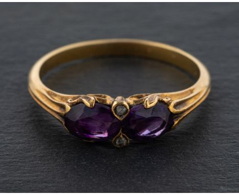 An oval, mixed-cut amethyst and rose-cut diamond ring, with reeded shoulders and acanthus leaf settings, length of ring head 
