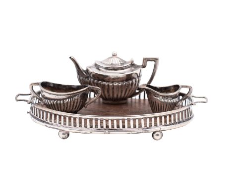 An Edward VII silver miniature three-piece tea service on an oval galleried twin-handled tray, makers Levi and Salaman, Birmi