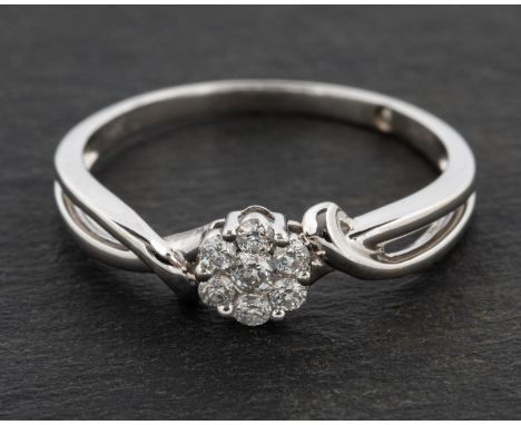 A round, brilliant-cut diamond, flowerhead cluster ring, total estimated diamond weight ca. 0.15cts, stamped '14K', length of