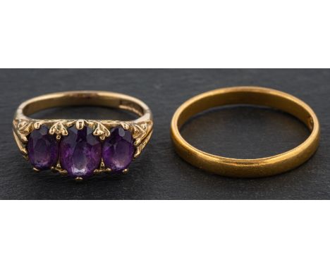 A 9ct gold, oval, mixed-cut amethyst three-stone ring, length of ring head ca. 1.4cm, ring size G, weight ca. 2.5gms, togethe