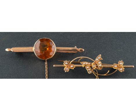 Two gemset brooches, including a round, mixed-cut citrine brooch and a seed pearl brooch with a butterfly motif, stamped '15C