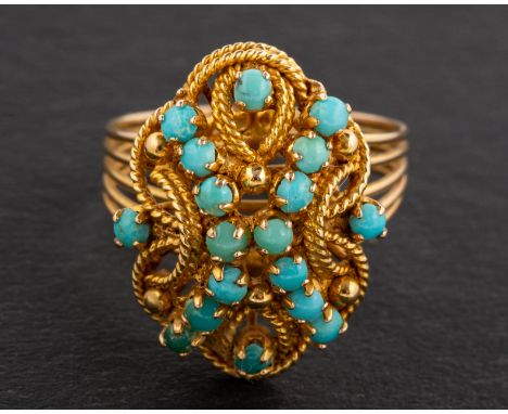 A cabochon-cut turquoise, openwork ring, length of ring head ca. 2cm, ring size M, total weight ca. 6gms.