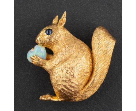 An 18ct gold squirrel brooch, with cabochon-cut sapphire eye, holding a  heart-shaped opal, with maker's mark for E Wolfe & C