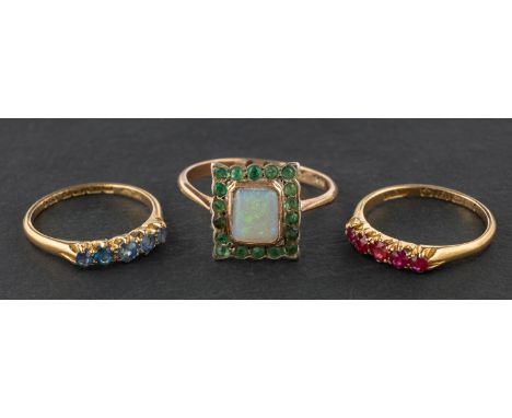 Three gemset rings, including a square, opal and emerald cluster ring, stamped '9CT SIL'; an 18ct gold, five-stone ruby ring;