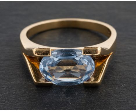 An oval, mixed-cut, light blue synthetic spinel ring, stamped '585', length of ring head ca.  1.8cm, ring size P, total weigh
