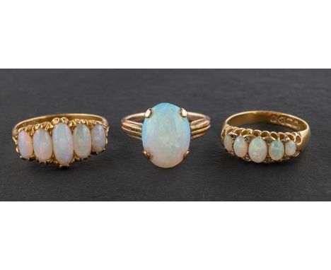 Three oval, cabochon-cut opal rings, including one single-stone ring, estimated opal weight ca. 1.35cts; an 18ct gold, five-s