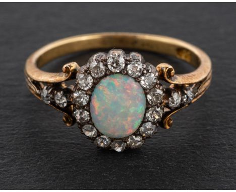 An oval, cabochon-cut opal and single-cut diamond cluster ring, estimated opal weight ca. 0.35ct, total estimated diamond wei