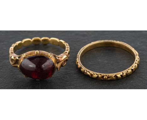 Two rings with decorative engraving, one with a foil backed, probably quartz, cabochon-cut stone, length of ring head ca. 1.8