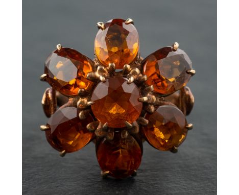 An oval and round, mixed-cut citrine cocktail ring, of flowerhead design, stamped '9CT', length of ring head ca. 2.2cm, ring 