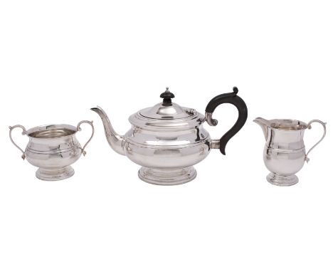 A George V silver three-piece tea service, makers Roberts &amp; Dore Ltd, Birmingham 1931 of circular form with ribbed decora