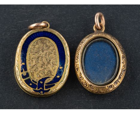 Two late 19th/ early 20th century, oval locket pendants, one with blue enamel buckle decoration, both with foliate engraving 
