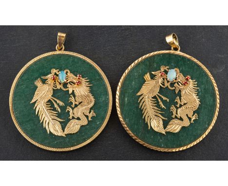 A pair of Chinese, circular, aventurine quartz pendants, depicting a phoenix and a dragon with red paste eyes, holding a cabo