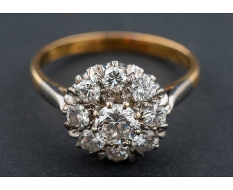 A round, brilliant-cut diamond cluster ring, total estimated diamond weight ca. 0.75ct, H-I colour, SI2-P1 clarity, stamped '